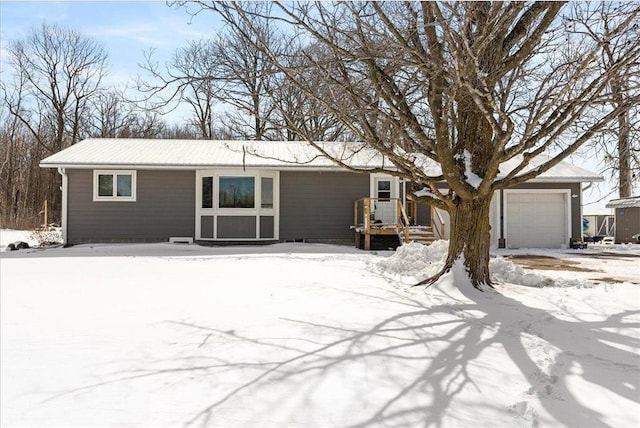 single story home featuring a garage and an outbuilding