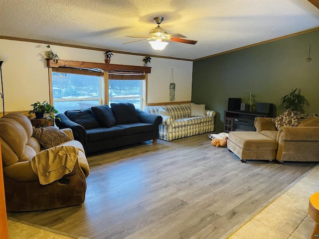 living area with a ceiling fan, light wood-style flooring, ornamental molding, and a textured ceiling