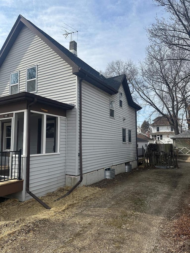 view of side of home featuring a chimney