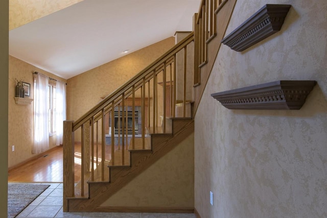 stairway with wallpapered walls