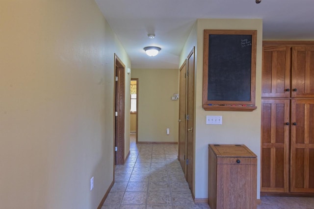 hallway featuring baseboards