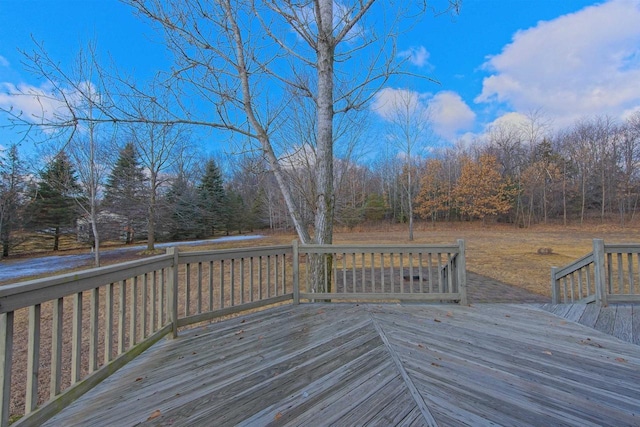 wooden terrace featuring a view of trees