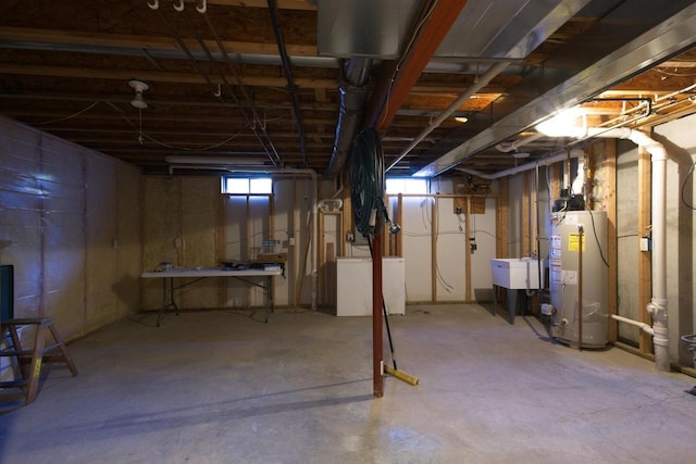 basement with gas water heater and a sink