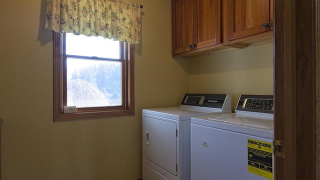 laundry room featuring a healthy amount of sunlight, cabinet space, and washing machine and clothes dryer