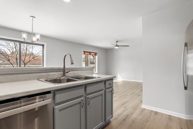 kitchen with plenty of natural light, appliances with stainless steel finishes, arched walkways, and a sink