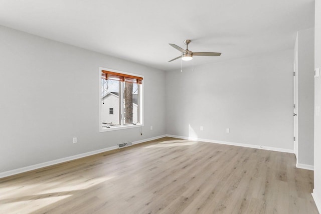 empty room with light wood finished floors, baseboards, visible vents, and ceiling fan