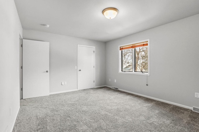 unfurnished bedroom featuring carpet flooring, visible vents, and baseboards