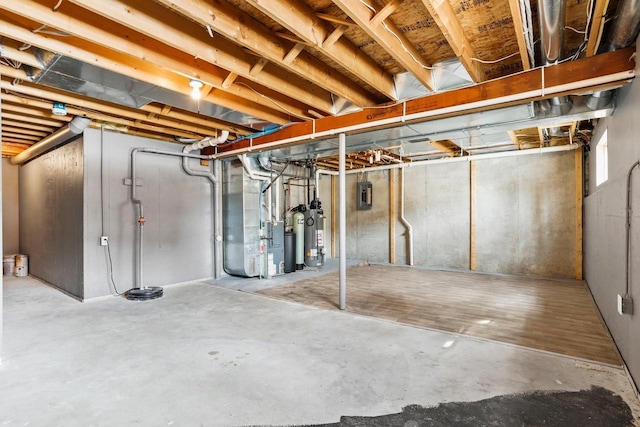 unfinished basement with gas water heater, electric panel, and heating unit