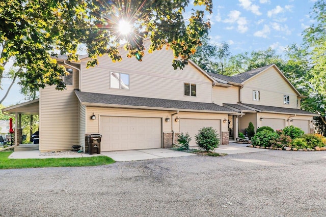 view of property with a garage and driveway