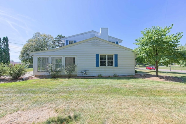 420 14th St, Baraboo, WI 53913 - exterior space with a sunroom, a yard, and a chimney