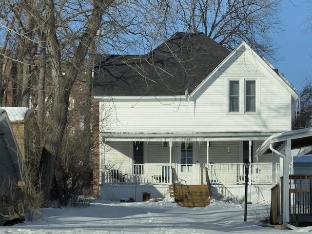 view of front of home featuring a porch and roof with shingles