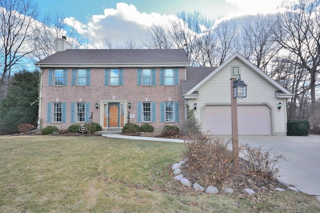 colonial-style house with concrete driveway, a chimney, an attached garage, a front lawn, and brick siding