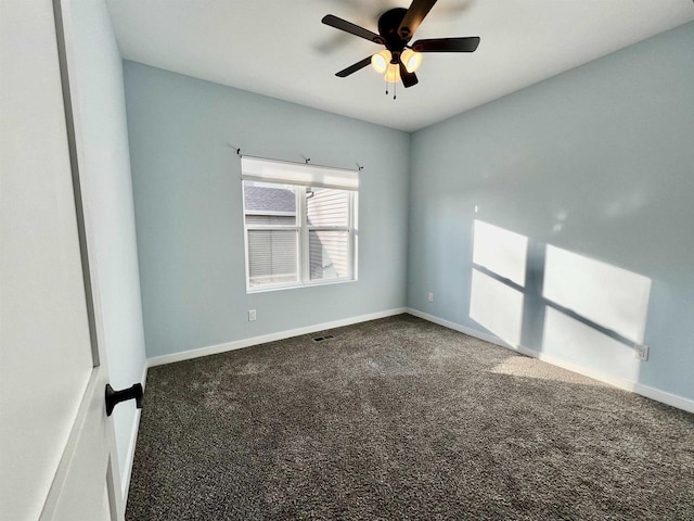 carpeted spare room featuring visible vents, ceiling fan, and baseboards