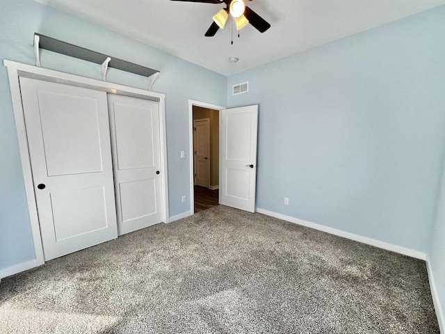 unfurnished bedroom featuring visible vents, baseboards, a ceiling fan, carpet floors, and a closet