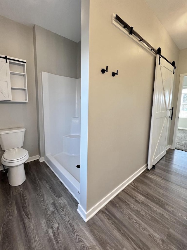 full bath with a walk in shower, toilet, baseboards, and wood finished floors