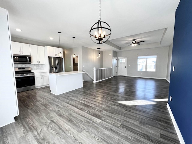 kitchen with white cabinetry, appliances with stainless steel finishes, and dark wood-style flooring