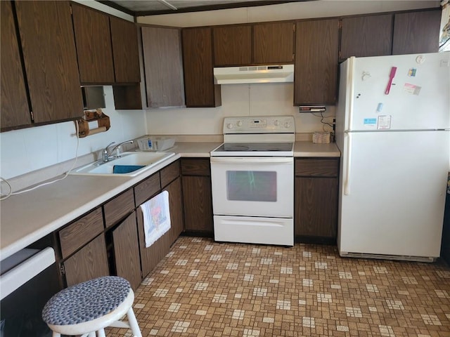 kitchen featuring white appliances, under cabinet range hood, light countertops, and a sink