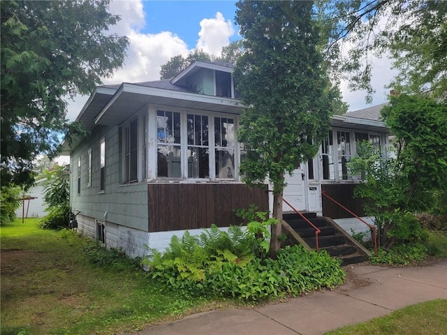 view of front facade with a sunroom