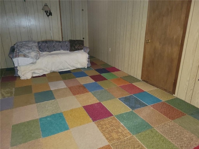 bedroom featuring wood walls and tile patterned floors