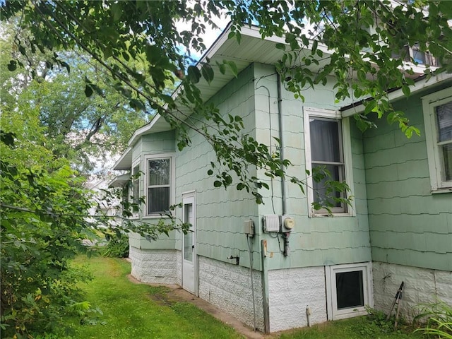 view of side of property with a lawn