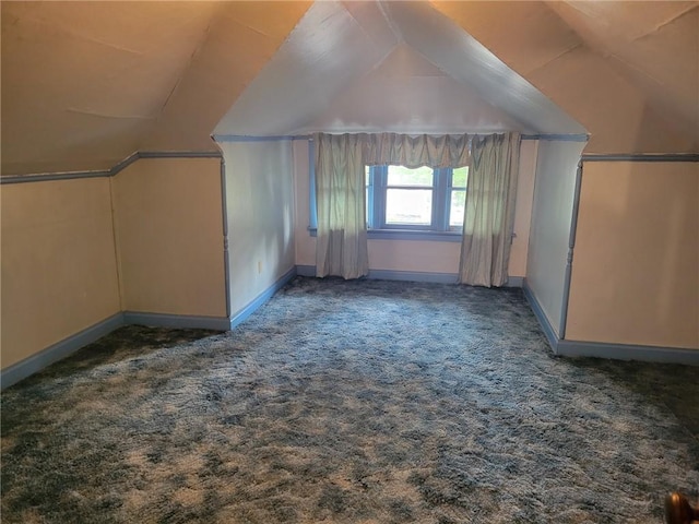 additional living space featuring lofted ceiling, carpet, and baseboards