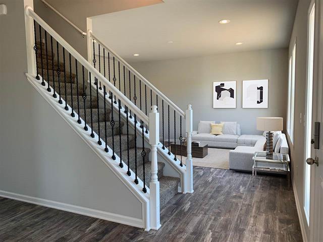 stairs with recessed lighting, baseboards, and wood finished floors