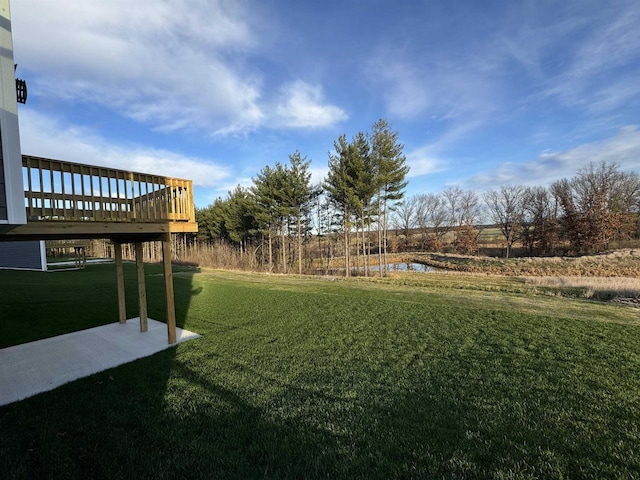 view of yard with a deck with water view