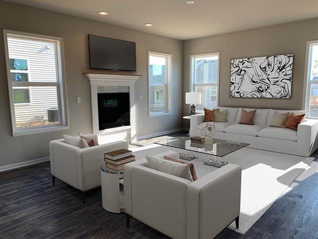 living room featuring a glass covered fireplace, dark wood finished floors, baseboards, and recessed lighting