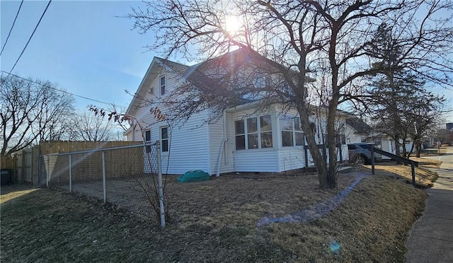 view of home's exterior with fence