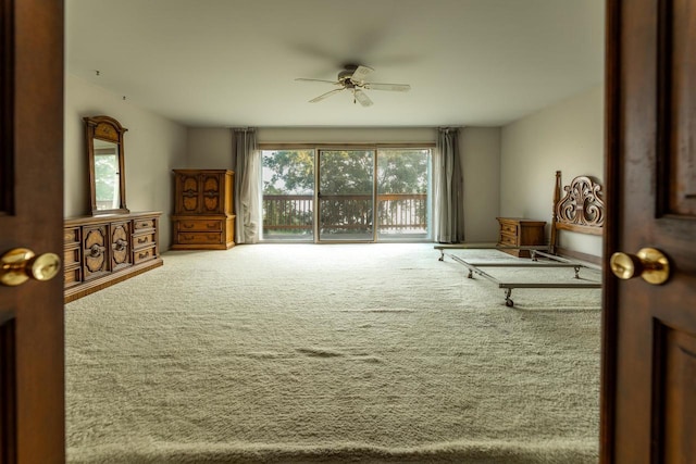 living area featuring carpet floors and ceiling fan