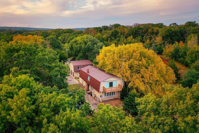 birds eye view of property with a view of trees