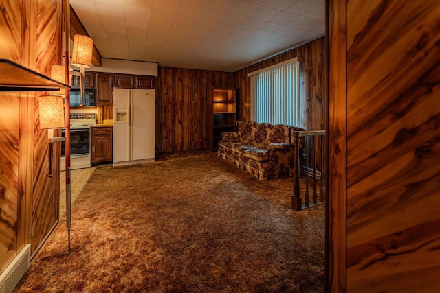 living room featuring dark carpet and wooden walls