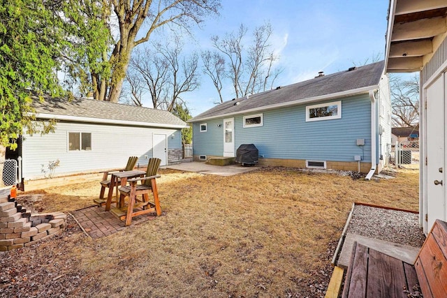 back of house with a patio area, a lawn, an outbuilding, and fence