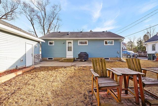 rear view of house with a patio and fence