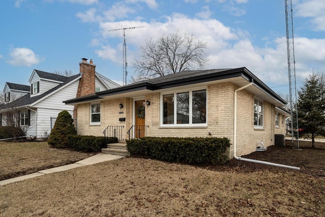 single story home featuring brick siding and central AC unit