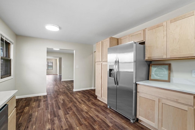 kitchen with baseboards, light countertops, appliances with stainless steel finishes, dark wood-style floors, and light brown cabinetry