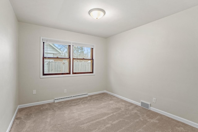 unfurnished room with carpet floors, a baseboard radiator, visible vents, and baseboards