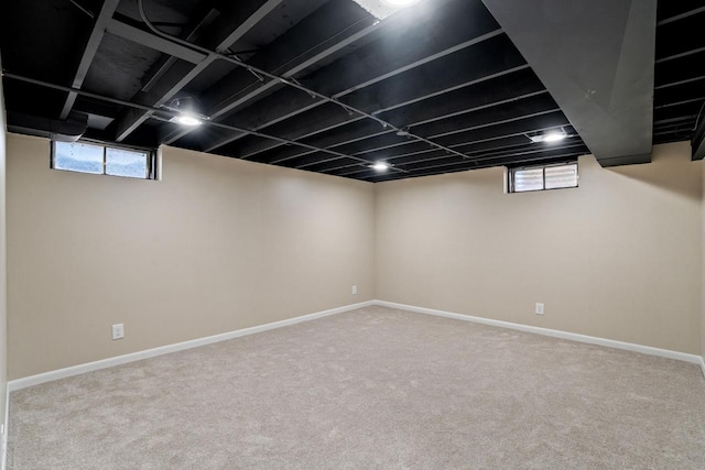 below grade area featuring carpet and baseboards