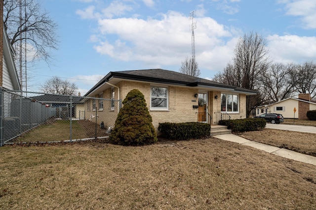 view of front of home featuring brick siding, a front yard, and fence