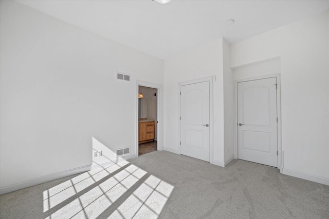 N37W22910 Wyndemere Dr, Pewaukee, WI 53072 - unfurnished bedroom featuring carpet floors, baseboards, and visible vents