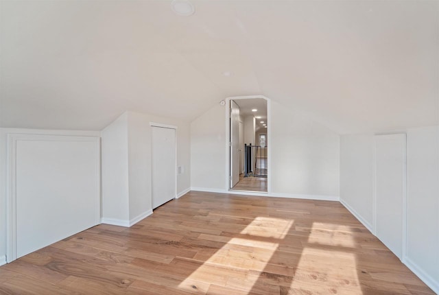 N8648 Linden Beach Rd, Fond Du Lac, WI 54937 - bonus room featuring light wood-style floors, vaulted ceiling, and baseboards