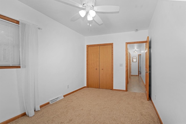 N8648 Linden Beach Rd, Fond Du Lac, WI 54937 - unfurnished bedroom featuring light colored carpet, baseboards, a closet, and ceiling fan