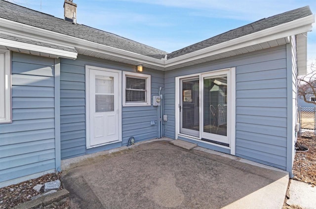 N8648 Linden Beach Rd, Fond Du Lac, WI 54937 - doorway to property with a patio, a shingled roof, and a chimney