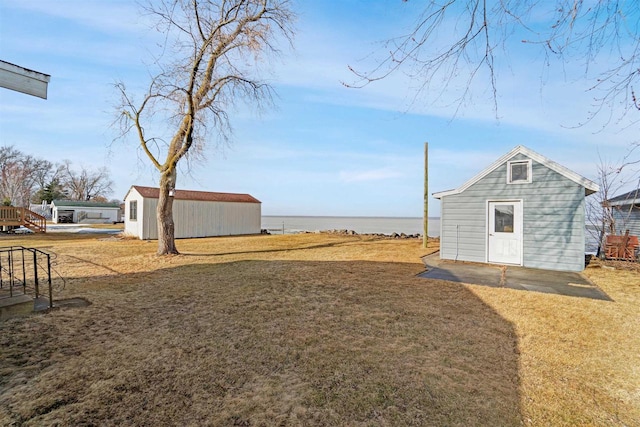 N8648 Linden Beach Rd, Fond Du Lac, WI 54937 - view of grassy yard with an outdoor structure and a water view