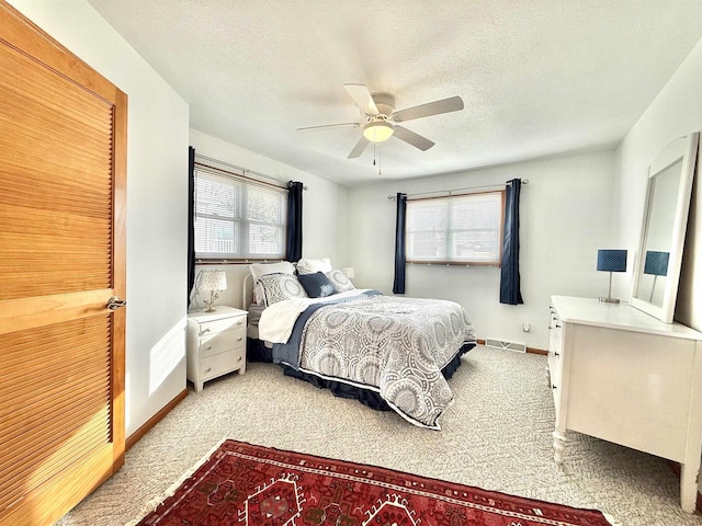 N8648 Linden Beach Rd, Fond Du Lac, WI 54937 - bedroom featuring carpet flooring, multiple windows, a textured ceiling, ceiling fan, and baseboards