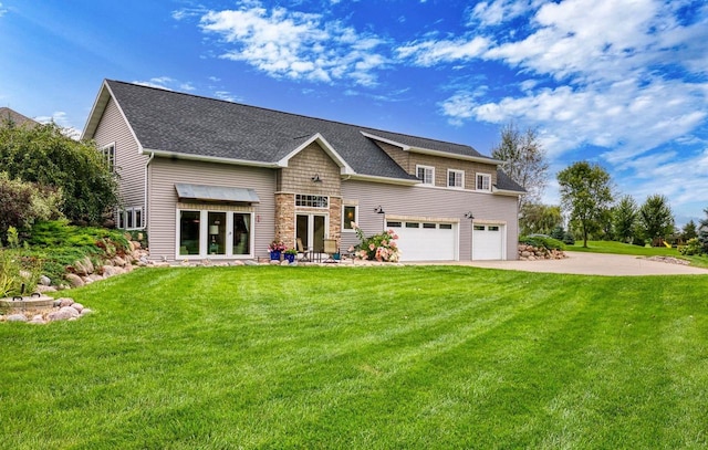 rear view of house featuring a garage, concrete driveway, a shingled roof, and a lawn