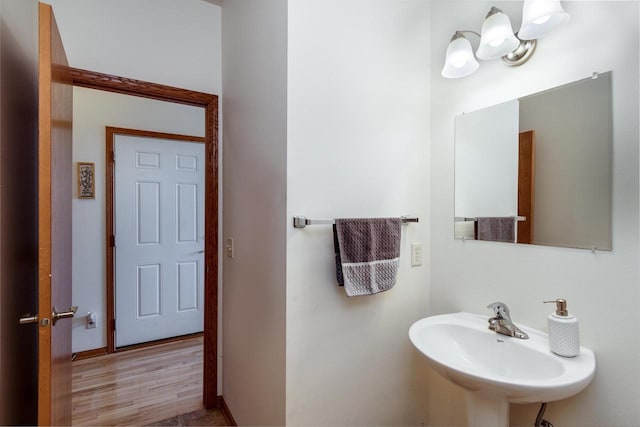 bathroom featuring wood finished floors and a sink