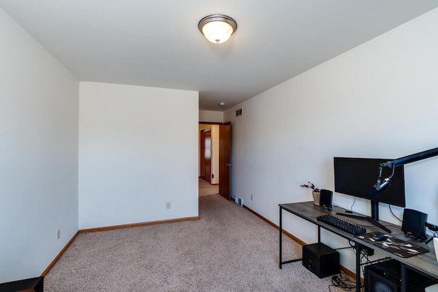 carpeted office with visible vents and baseboards