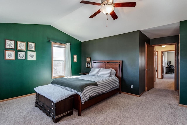 carpeted bedroom with vaulted ceiling, baseboards, and ceiling fan