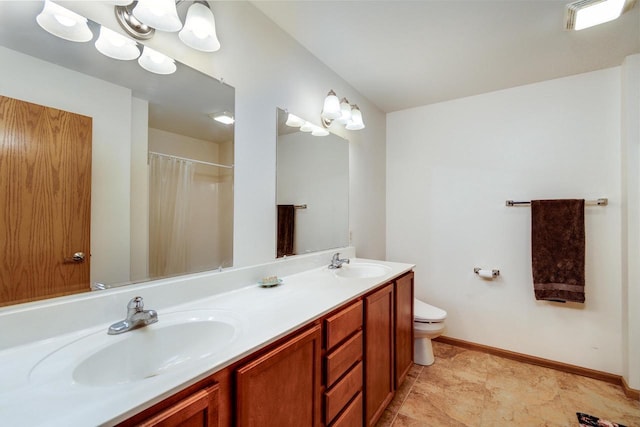 bathroom featuring double vanity, toilet, baseboards, and a sink